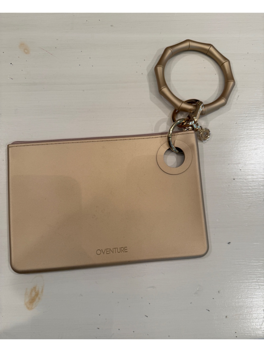 Champagne/Gold Oventure wristlet clutch with signature Keyring